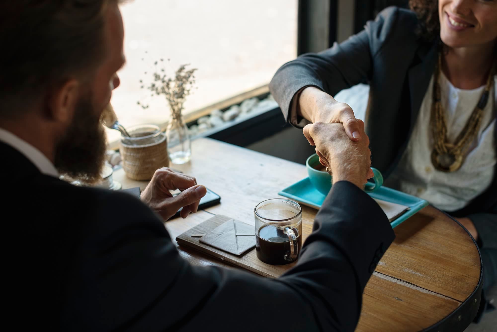 A candidate and an employer shaking hands after an interview